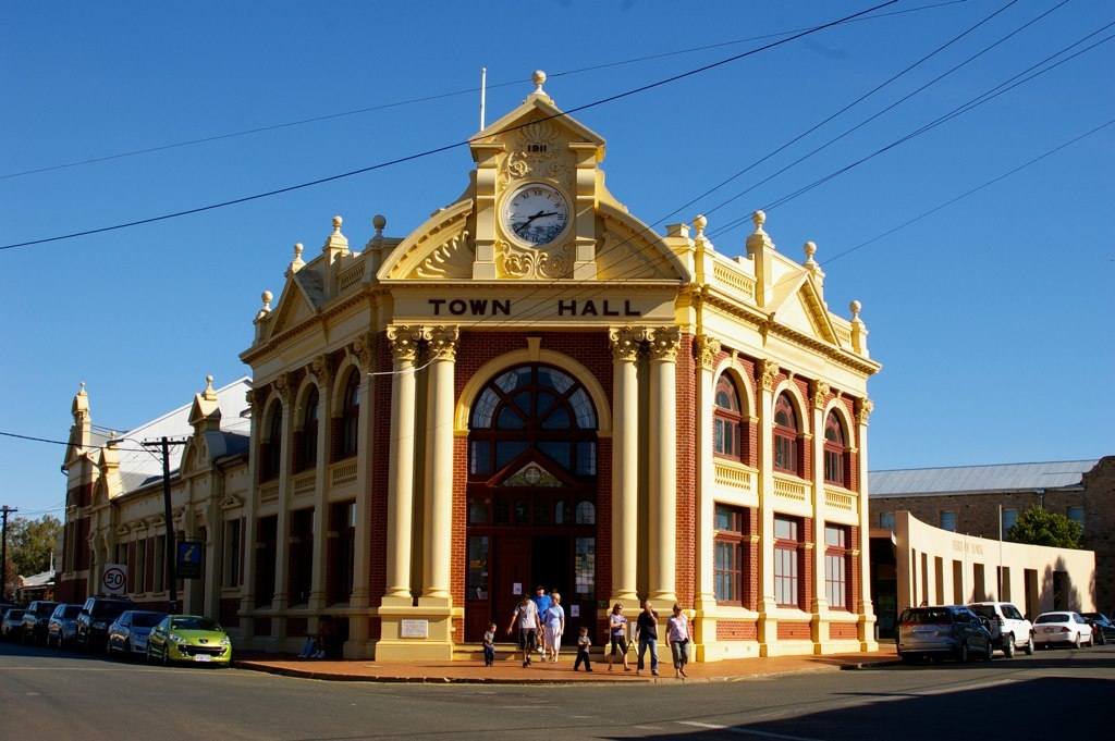 Modern, brightly painted town hall under a blue sky