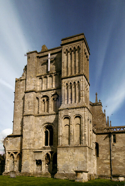 Photo showing the end of a medieval church. The building has several layers of construction, with arches on each