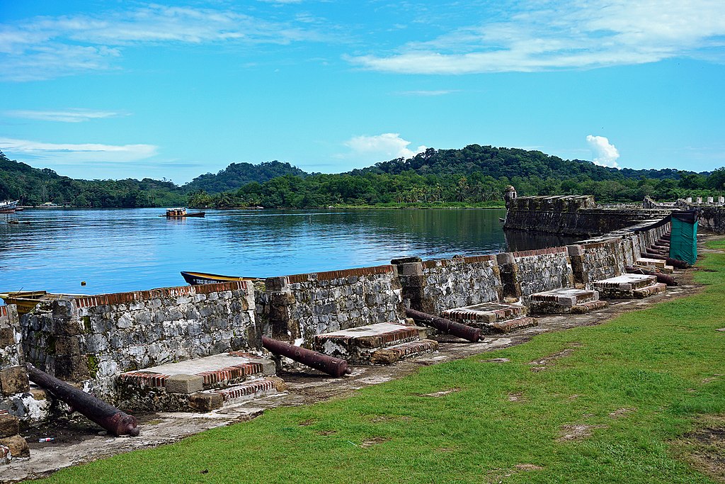 A wall with a bay in the background