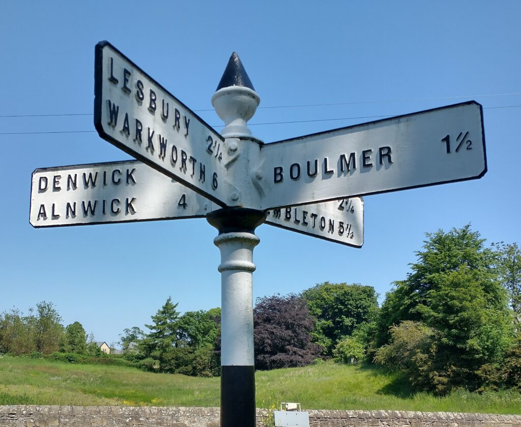 Signpost showing Northumberland place-names including Denwick, Alnwick and Warkworth