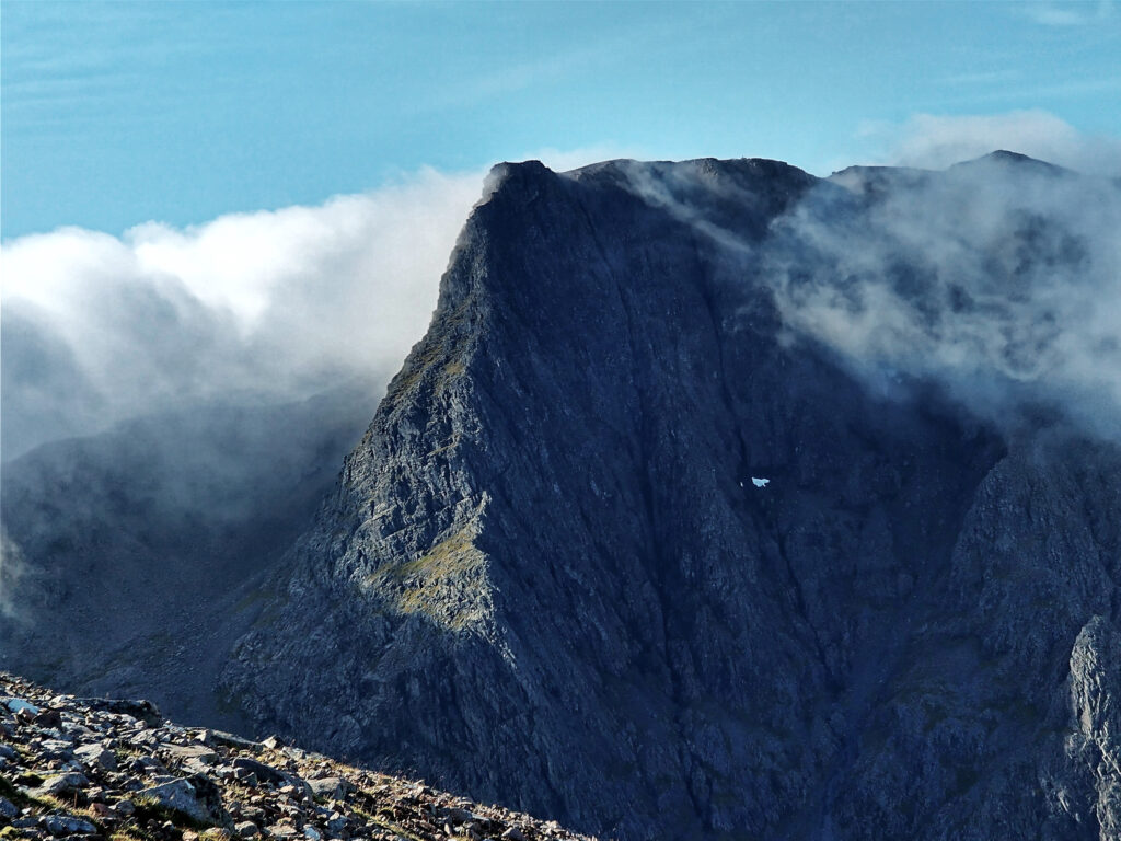 Towering rocks of Ben Nevis against a blue sky