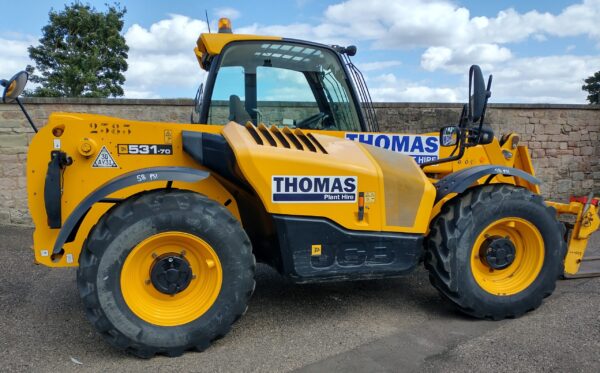 Digger with 'Thomas Plant Hire' painted on the side